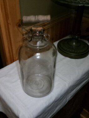 Antique one gallon vinegar bottle with wood handle